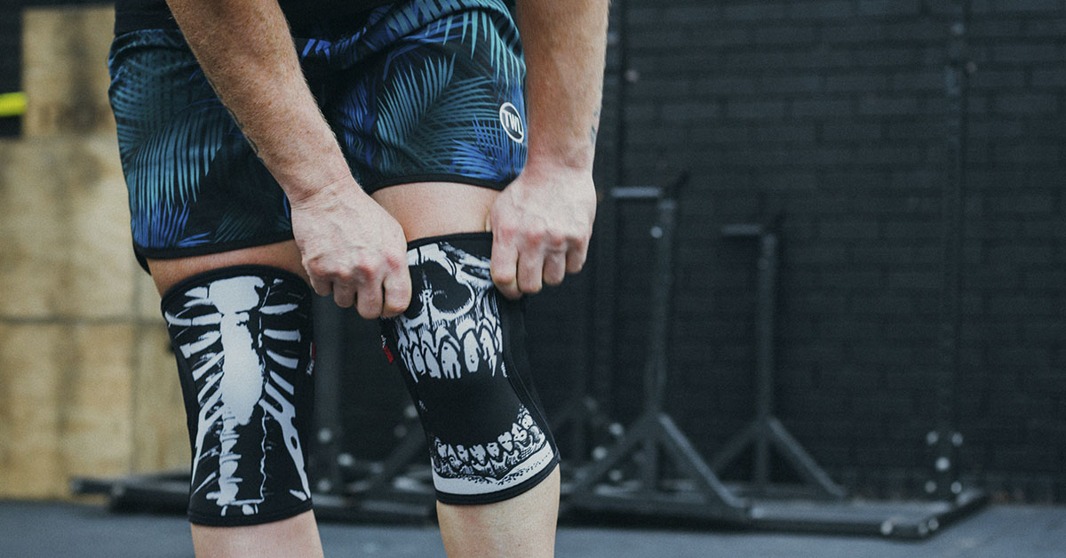 athlete putting on rocktape assassins knee sleeves