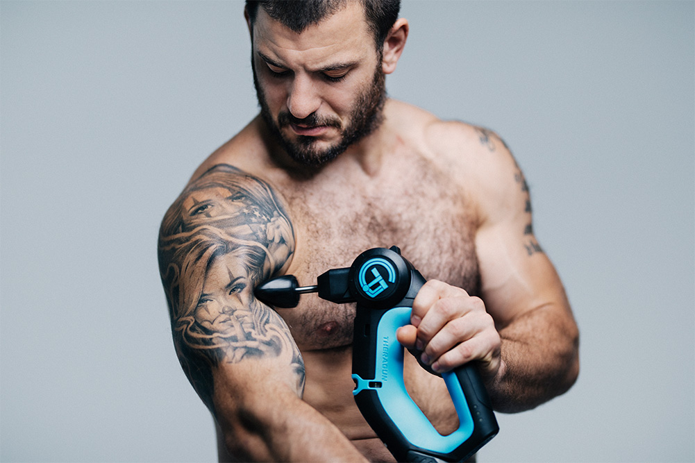 mat fraser using theragun