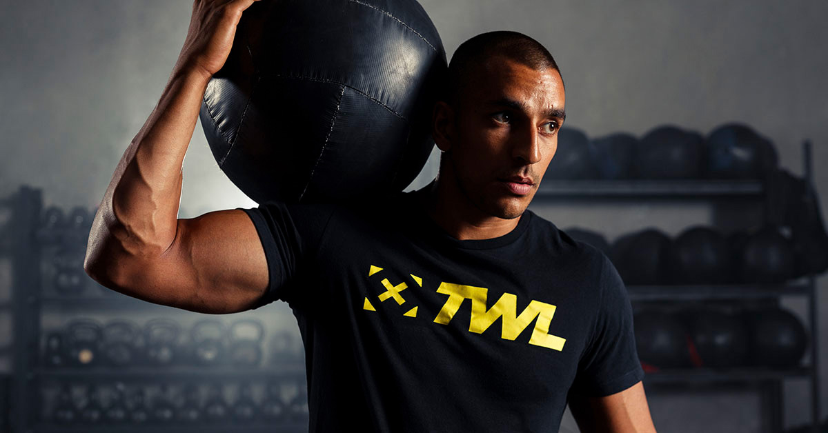 athlete holding weighted ball on shoulder