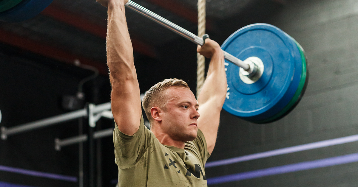 male athlete with barbell overhead