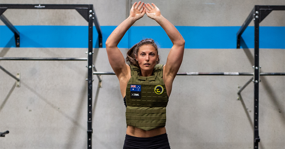 female athlete doing burpees with weighted vest