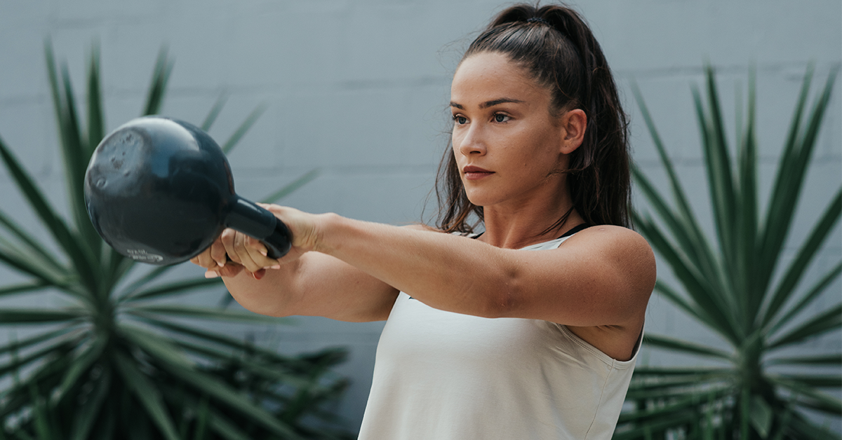 female athlete doing russian kettlebell swings