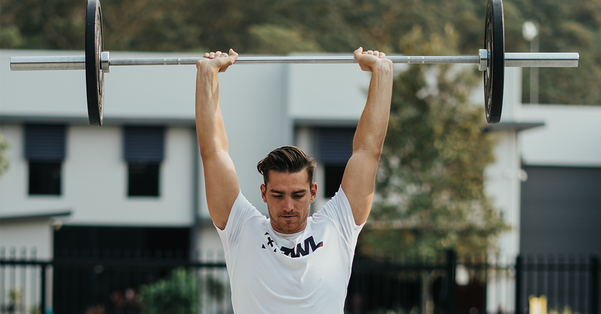 male athlete performing push jerk