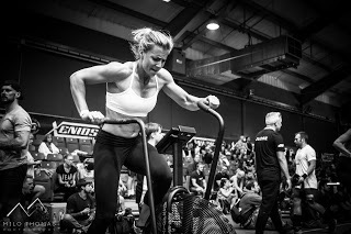 female crossfit athlete training on bike