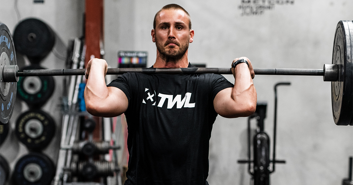 man with barbell in front rack position