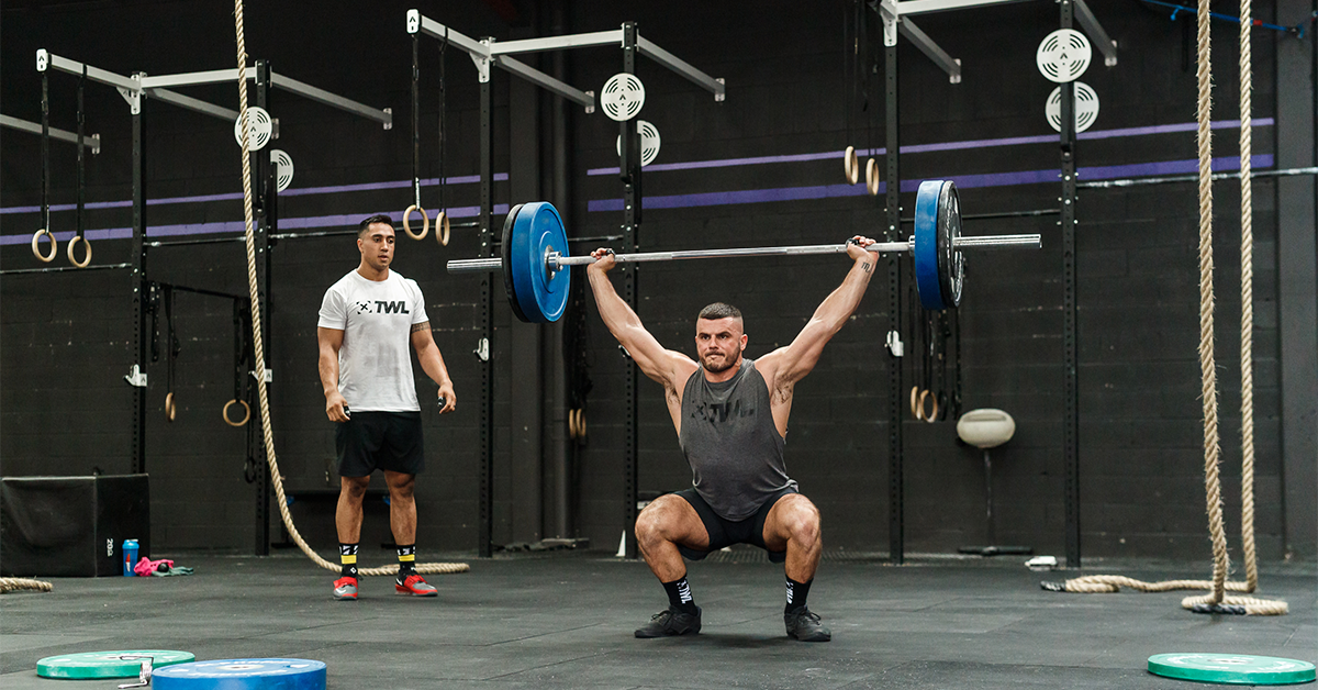 male athlete performing snatch lift