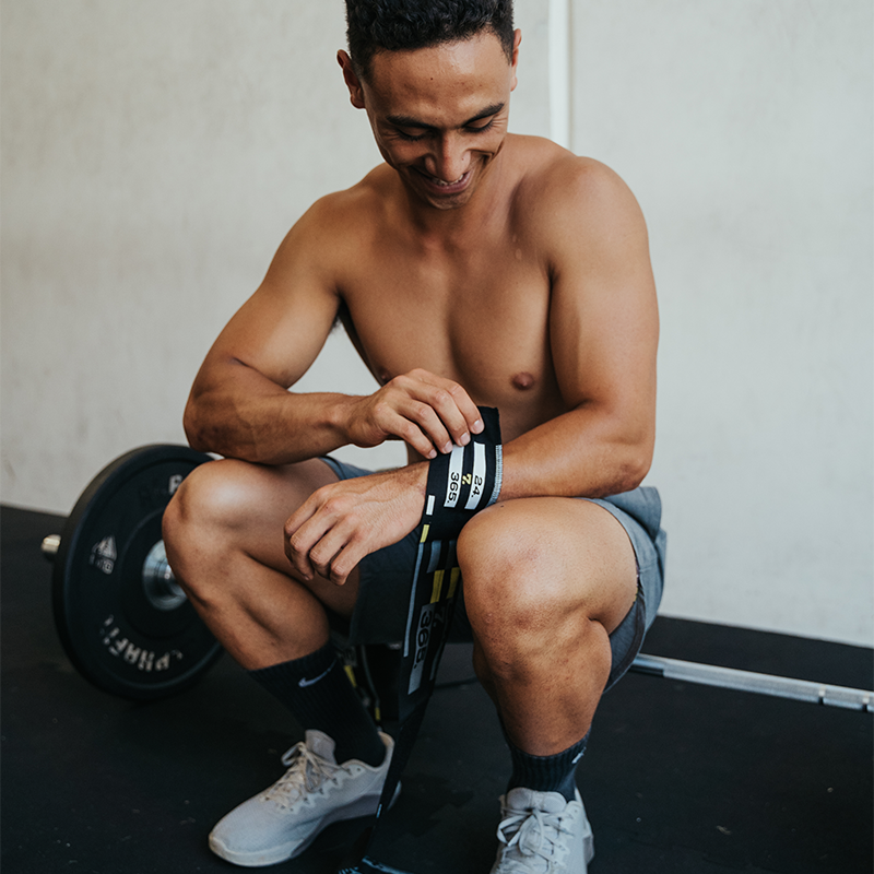 athlete putting on wraps to support wrist mobility