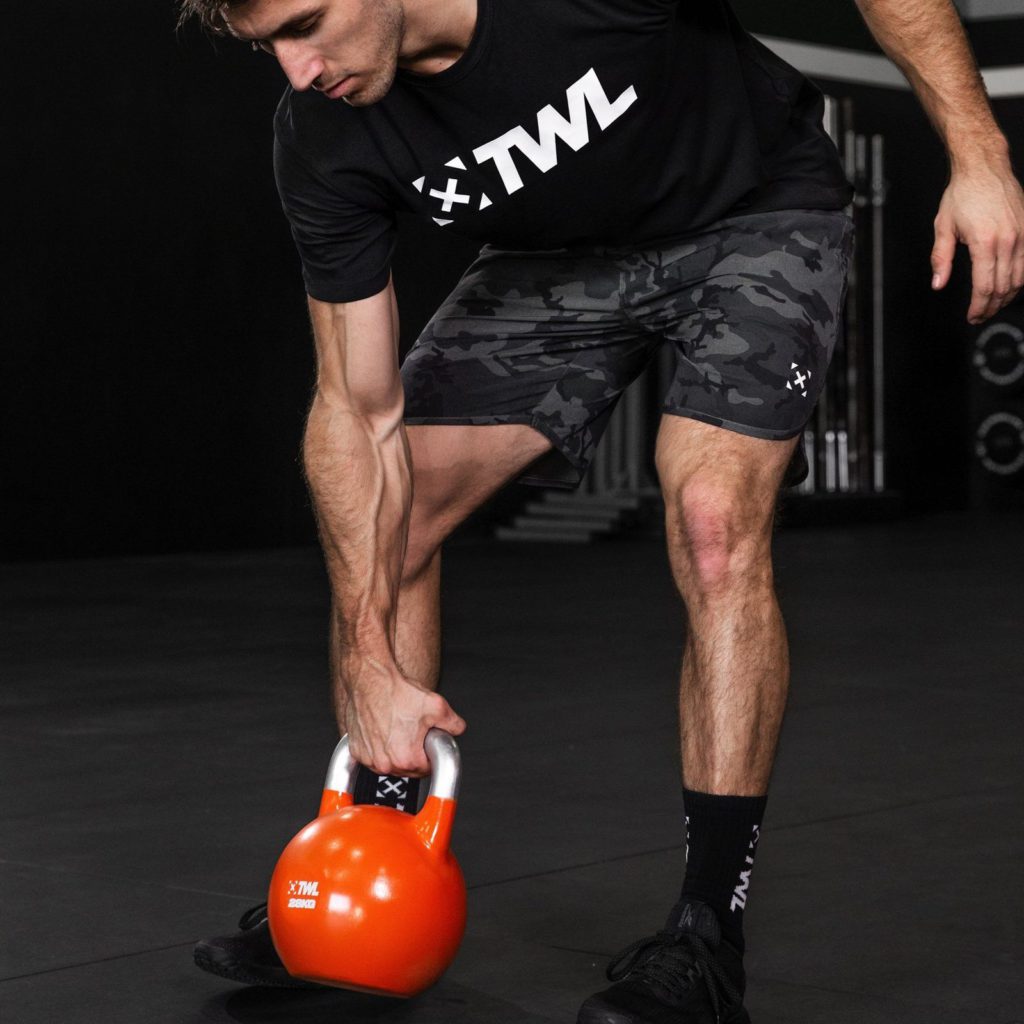 athlete using kettlebell as best home gym equipment for small spaces