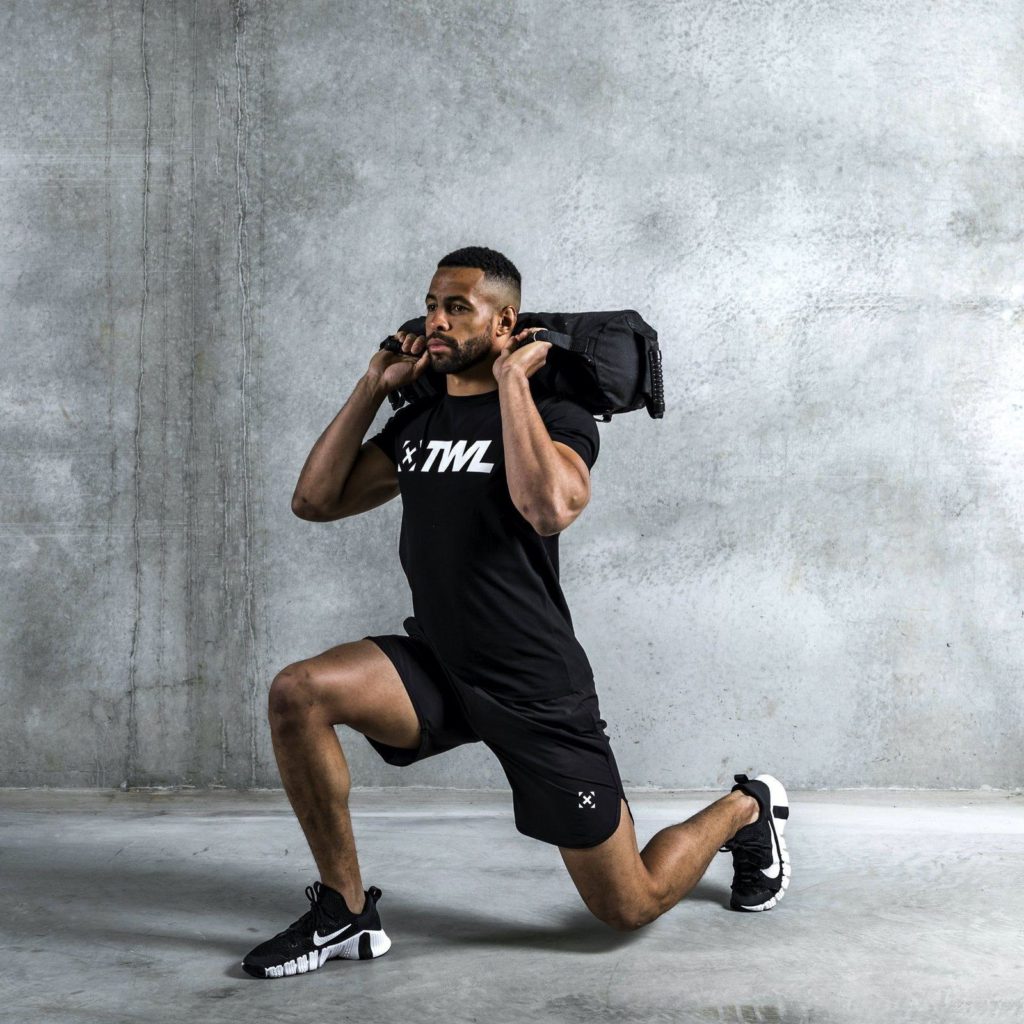 athlete using sandbag