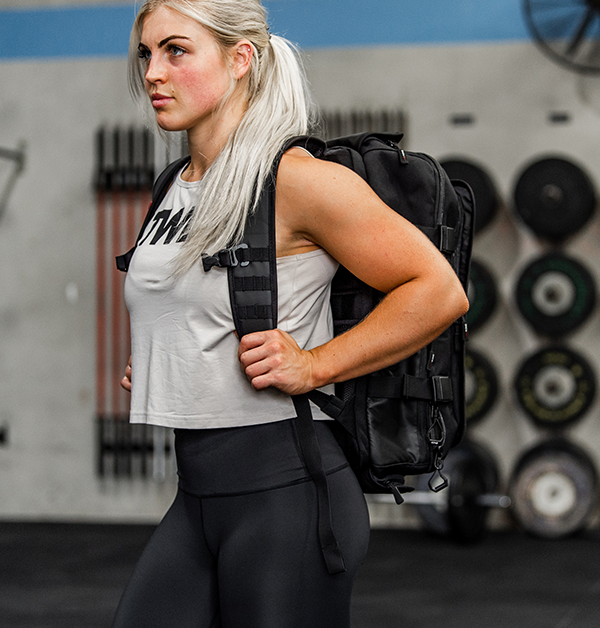 female athlete carrying gym bag