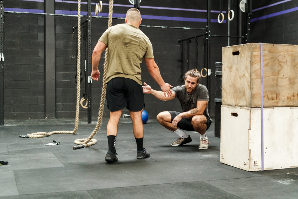 two male athletes high-fiving and enjoying the mental health benefits of exercise