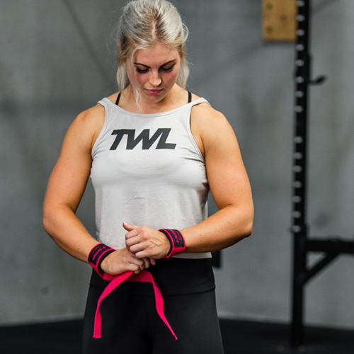 female athlete putting on wrist wraps