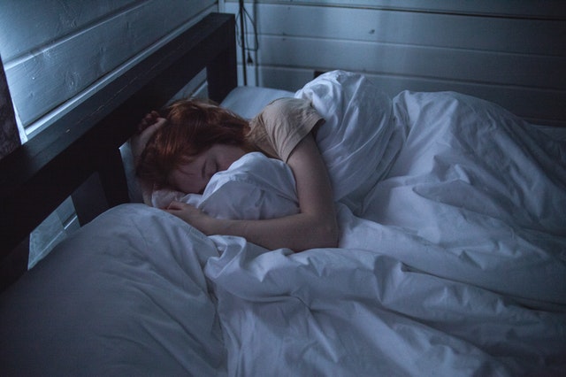woman sleeping to recover from workout