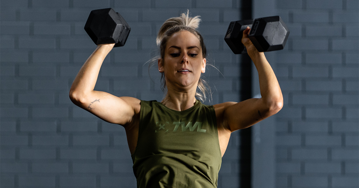 female athlete performing man maker exercise