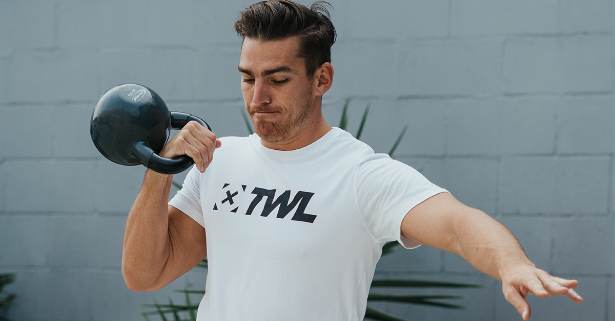 male athlete doing kettlebell squat