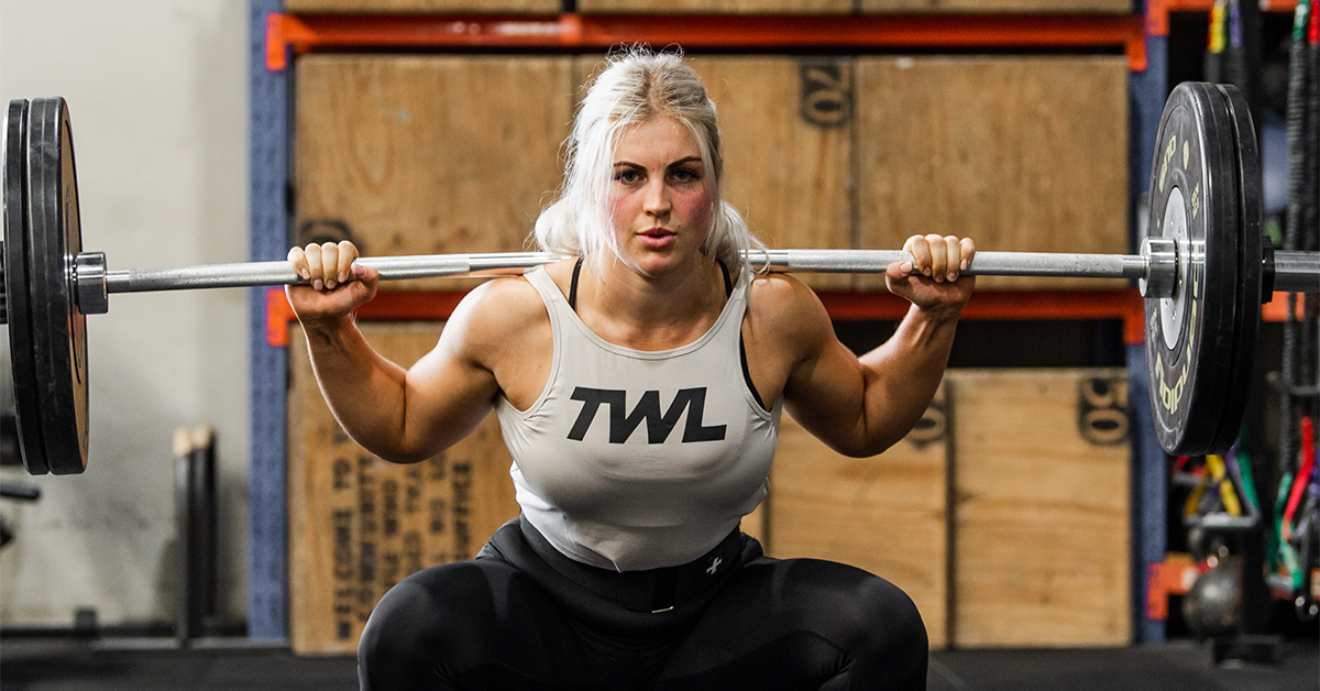 female athlete performing pin squat