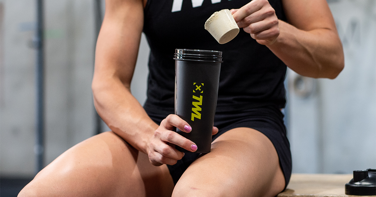 female athlete making protein shake