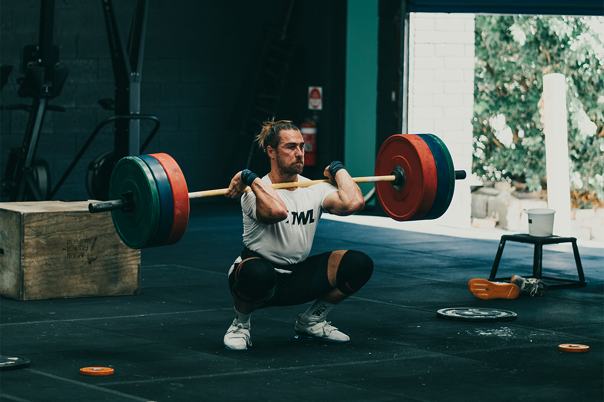 Khan Porter squatting heavy barbell