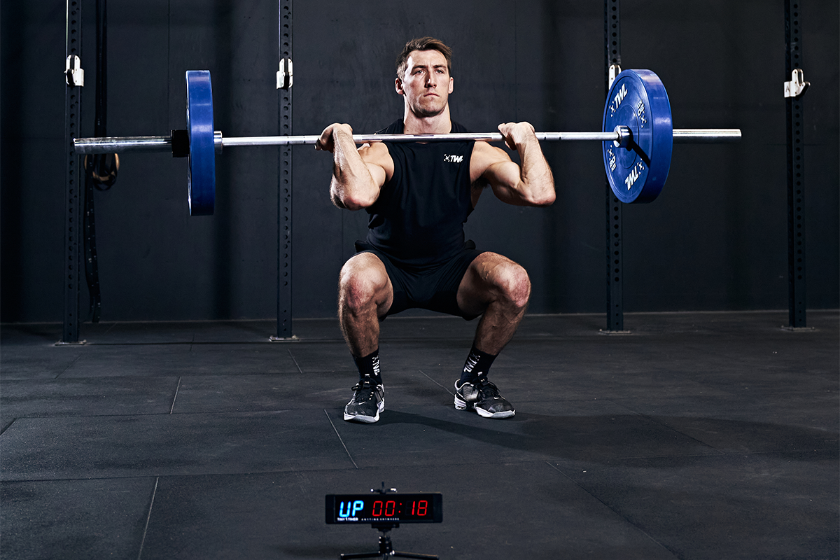 athlete performing barbell thruster