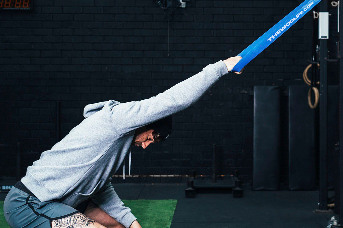 male athlete doing back exercises with resistance bands