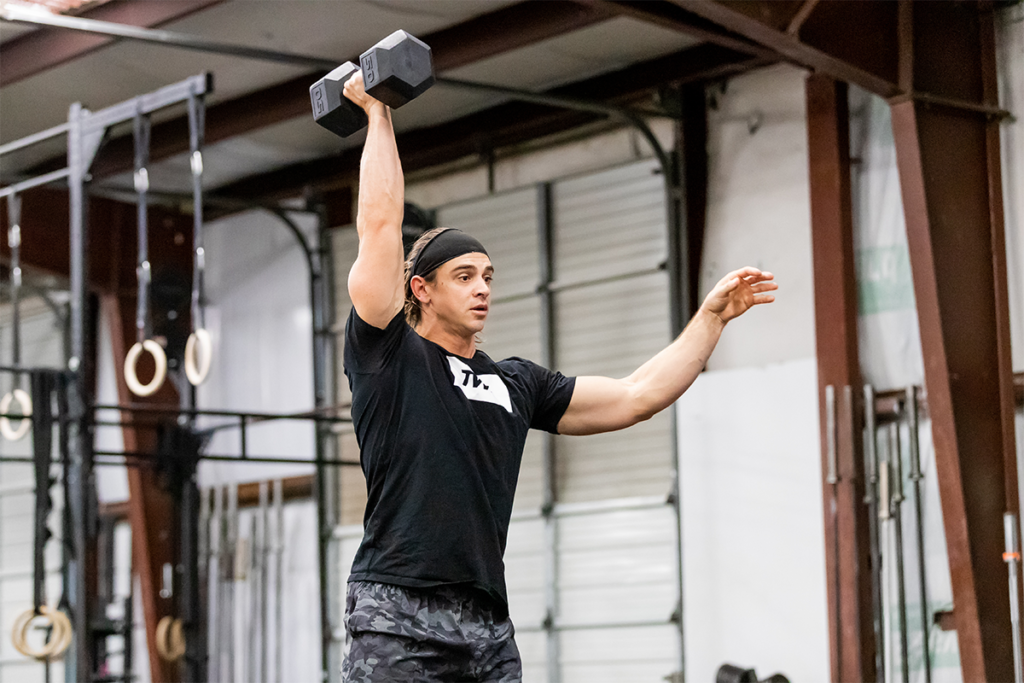 male athlete doing dumbbell exercise