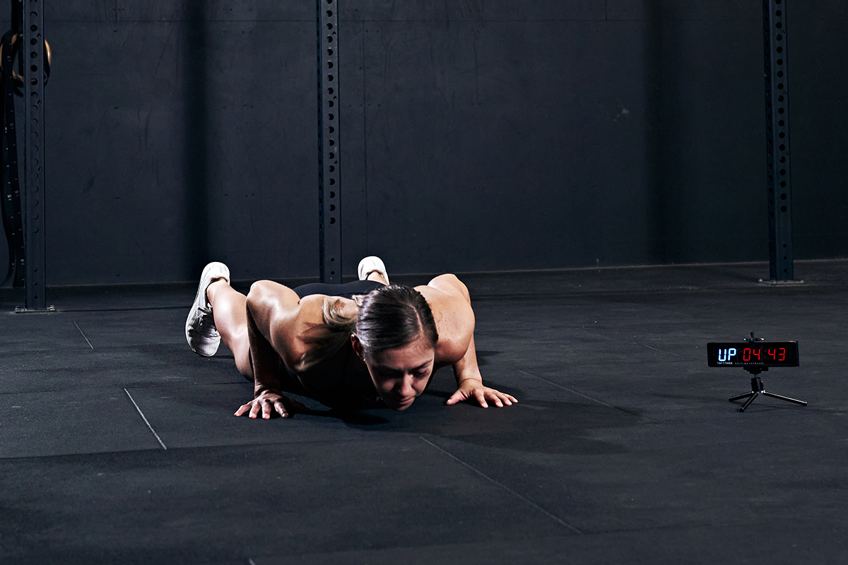 female athlete performing burpee