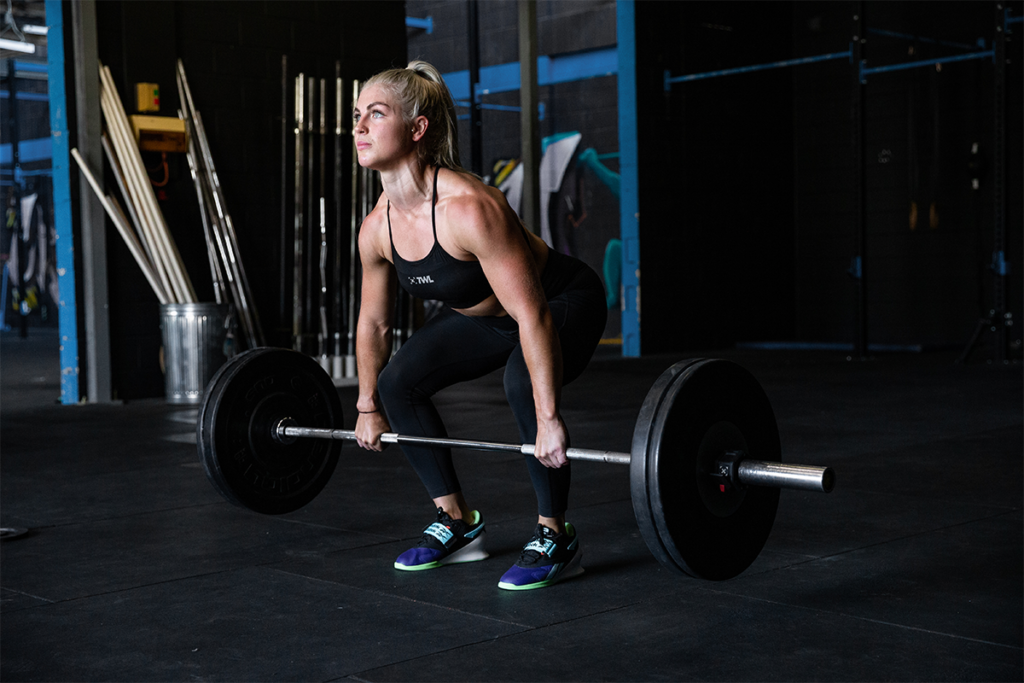 female athlete performing clean deadlift