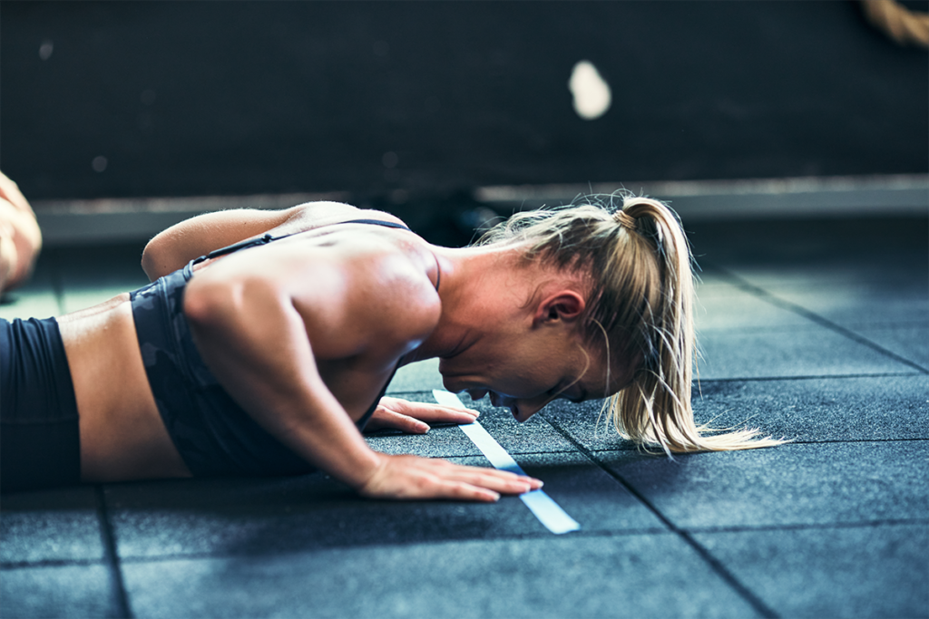 woman practicing how to get better at burpees
