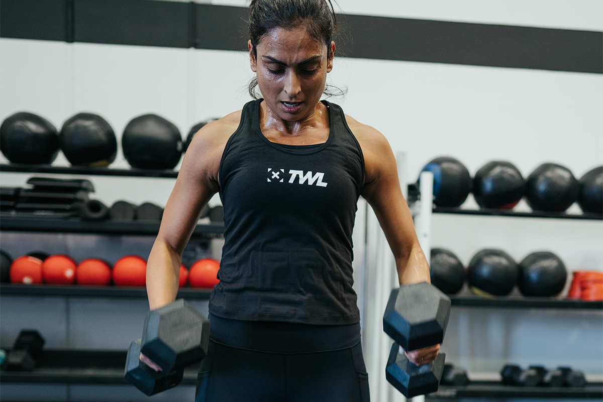 female athlete performing dumbbell row