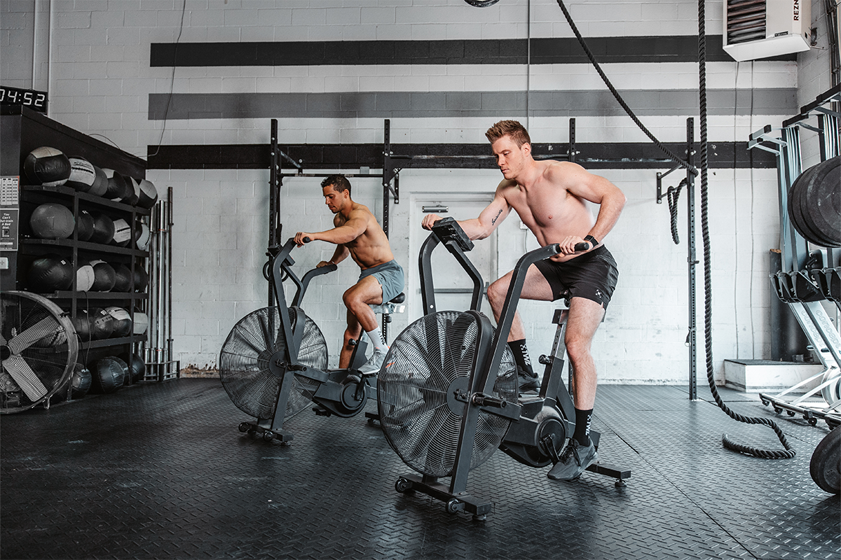 two men on stationary bikes